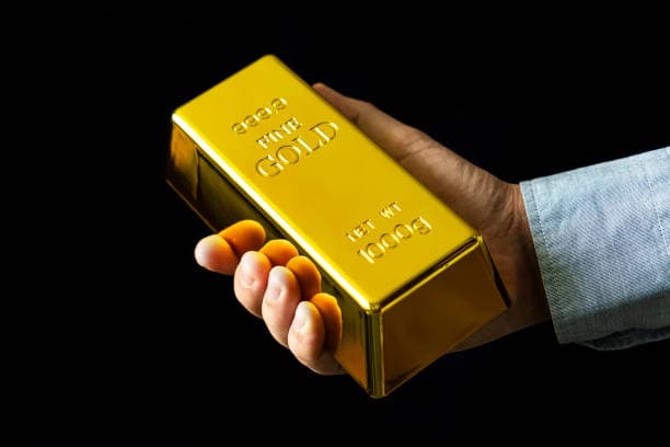 Gold bar held in hands